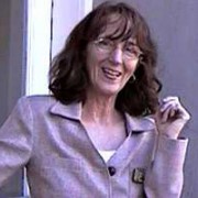 Lori Schultz Smiling woman with glasses and shoulder-length dark hair